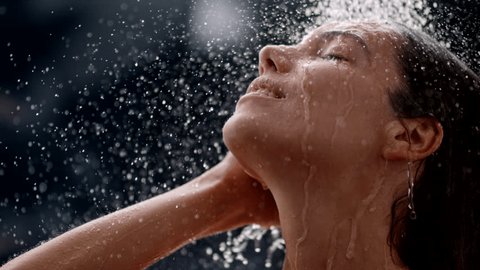 slow motion of a woman taking a shower, beautiful girl washing and enjoy herself under a shower, close up of hands and shoulder 스톡 비디오