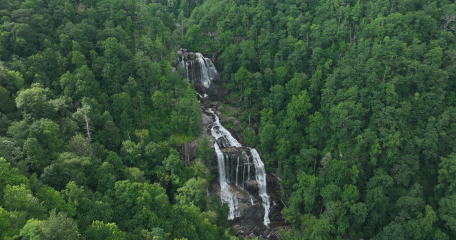 Amazing summer landscape with forest river waters falling down in big waterfall with clear water between rocky boulders in Nantahala National Forest. Whitewater Falls, North Carolina, USA