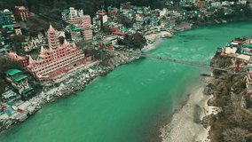 An aerial view of the beautiful holy Ganga river, Lakshman Jhula bridge, Tera Manzil Temple, and Trimbakeshwar. Rishikesh is a holy town and a popular travel destination in India.