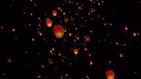 Golden color floating lantern. A large group of Chinese flying lanterns. Chinese sky lanterns floating in a dark night sky