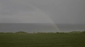Rainbow in the sky, maritime landscape. rainbow over the sea. Video 4K