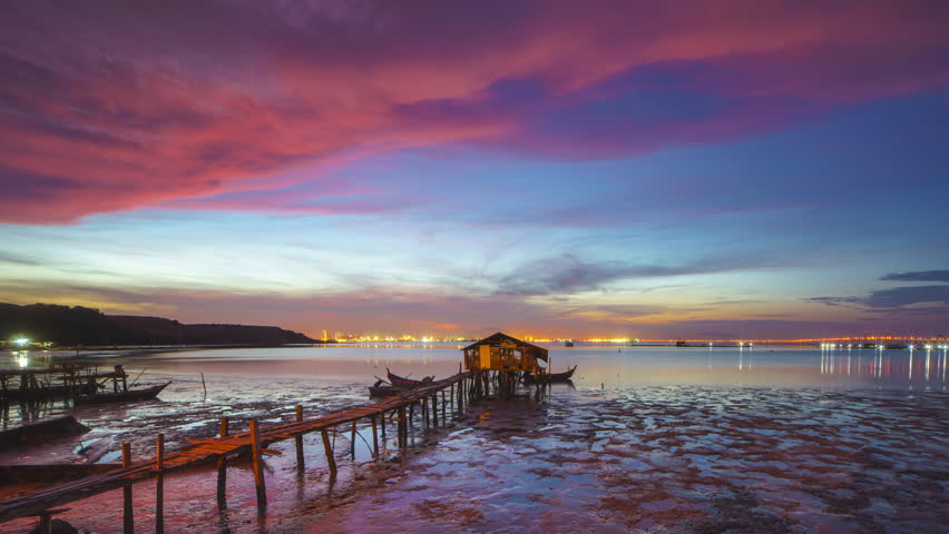 Beautiful and colorful time lapse of a silhouette old jetty during beautiful sunrise in Penang Island , Malaysia. Zoom out motion timelapse. Prores 4KUHD