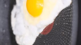 Cooking an egg in a pan. Cooking. Fried egg. Vertical video