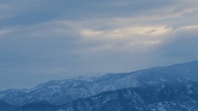 Mountain Range With Clouds Drifting In Foreground. View Mountain With Clouds. Timelapse. - Powered by Shutterstock - Get 15% off with code: PIKWIZARD15