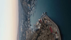 Bay of the sea, mountains, rocks, embankment. Aerial view. Vertical Video