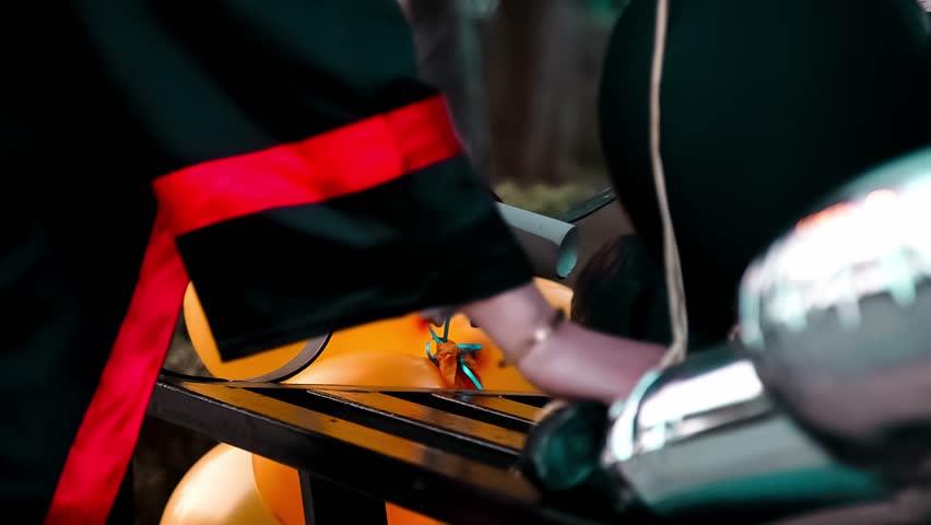 A Fresh graduate holding the certificate and put it on the chair 