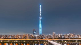 Aerial view time lapse 4k Video of Tokyo sky tree and Tokyo city at night at Tokyo, Japan. Zoom out