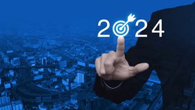 Businessman pressing 2024 letter with goal icon over modern office city tower, street and expressway, Business happy new year 2024 success concept - Powered by Shutterstock - Get 15% off with code: PIKWIZARD15