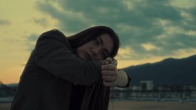 Close up portrait of young Asian girl sitting on rooftop with lighter during beautiful sunset - Powered by Shutterstock - Get 15% off with code: PIKWIZARD15
