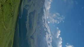 Beautiful view of Mount Elbrus and clouds before sunset, North Caucasus mountains, Russia, timelapse. Vertical video