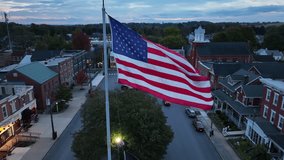 Small town America square with American flag and historic buildings. Aerial view at dusk. - Powered by Shutterstock - Get 15% off with code: PIKWIZARD15