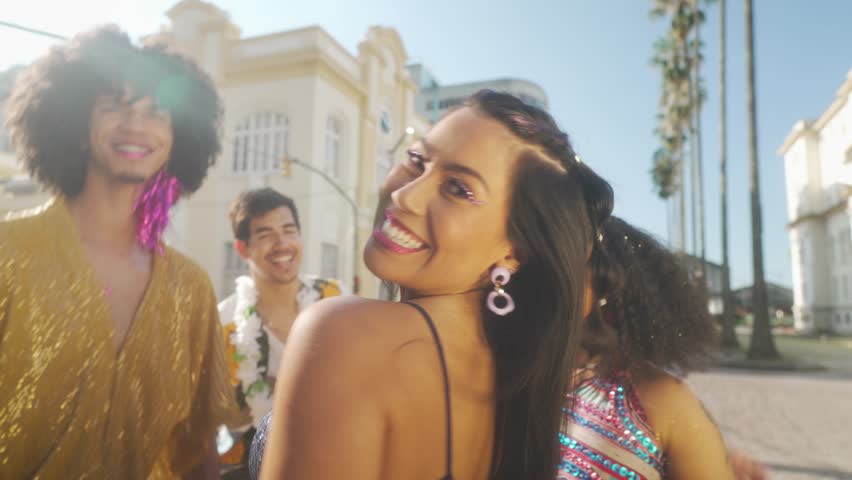 Carnival Bliss in Brazilian Sunshine, Smiling Woman with Friends Celebrating in the Street, Festive Costumes and Dance Moves. Royalty-Free Stock Footage #3403553021