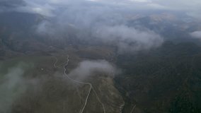 Low clouds in the mountains. Aerial view of low fog in mountainous area