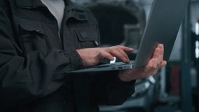 Close up male hands use laptop computer diagnostics checking car in workshop auto repair service unknown man mechanic specialist engineer conducting diagnostics test search vehicle details on website - Powered by Shutterstock - Get 15% off with code: PIKWIZARD15