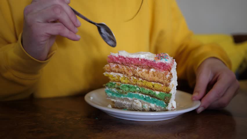 Woman eating sweet piece of cake in a cafeteria in Malta