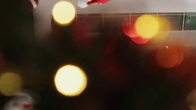 Vertical video Manager dressed as Santa during Christmas season holding team meeting, presenting business charts on digital screen. Team leader in festive decorated office talking with staff members - Powered by Shutterstock - Get 15% off with code: PIKWIZARD15