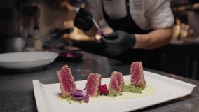 Chef Is decorating with flowers tuna fish fillets for second course in kitchen - Powered by Shutterstock - Get 15% off with code: PIKWIZARD15
