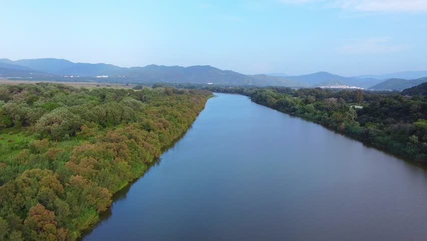 Aerial View of  river, Beautiful Aerial View of African Jungles forest and River, Landscape in aerial drone shot. Adove calm tranquil river in Jijel Algeria North Africa, River and green fores trees.