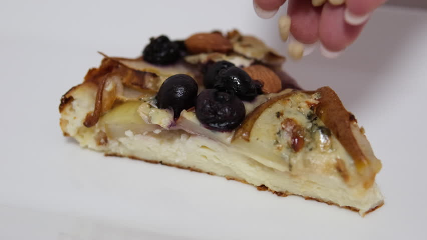 sprinkle pine nuts on a pear pie apple strudel berries almond nuts on a white plate curd cheesecake with fruit Royalty-Free Stock Footage #3403830535