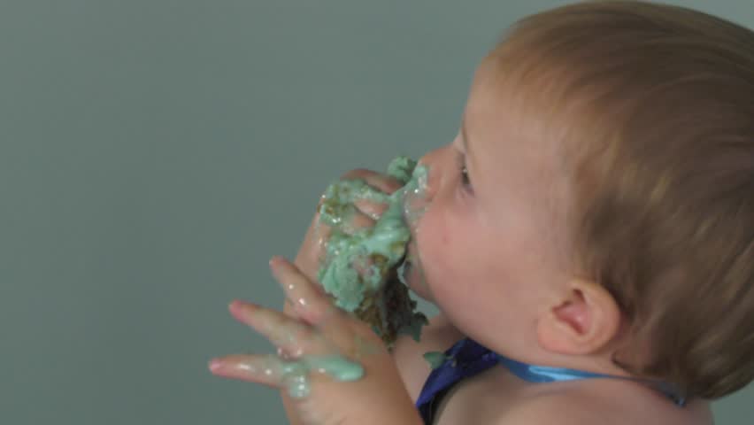 baby boy eating his first cake and loving it 4k