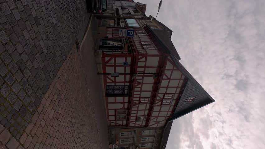 Old house in the city. Building with sky and clouds. A walk through the historic streets in the center of the old town. Old historic street. Germany.