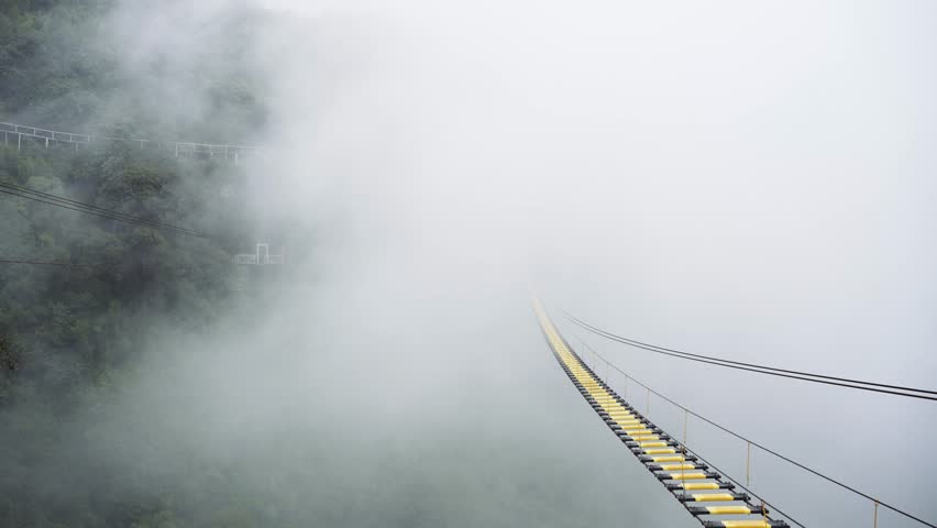 foggy mountain forest with robe bridge