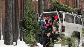 A Young couple is sitting in a trunk of retro car with holiday's brights in background. New Year's gifts, plaid. girl, happiness, Christmas celebration, holiday. - Powered by Shutterstock - Get 15% off with code: PIKWIZARD15