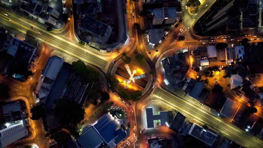 Roundabout Traffic At Goiania Goias Brazil. Intersection Cityscape. Night Building Downtown Cityscape. Night Outdoors Downtown City Night Panning Wide. Night Cityscape Building Highrise. Royalty-Free Stock Footage #3403987317