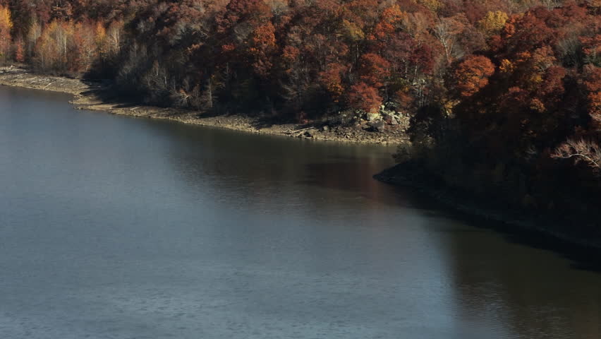Dense Autumn Forest Surrounding Lake Fort Smith State Park, Arkansas, United States - Aerial Drone Shot