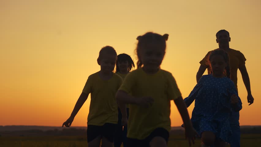 happy family in the park. group of children running silhouette and parents in nature in the park at sunset. happy sun family kid dream concept. friendly family runs silhouette in the lifestyle park Royalty-Free Stock Footage #3404024425