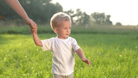 mother and baby son walking in the park. happy family walking in the park in nature relaxing outdoors. happy family kid dream concept. mother and child lifestyle walking in the park - Powered by Shutterstock - Get 15% off with code: PIKWIZARD15