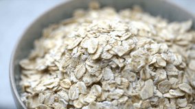 Oatmeal in a bowl. Rotating shot of oats. Wholegrain healthy cooking. Plant based vegan food. High resolution 4k vegetarian cooking shallow depth of field footage.