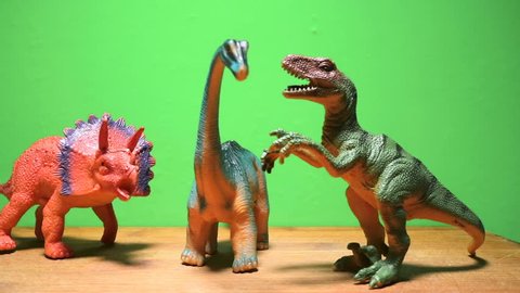 Dinosaurs of the Jurassic period close-up on a green background. Herbivores and predators. Tyrannosaurus, triceratops and diplodocus.