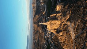 Cristo de Monteagudo, Murcia, Spain. Aerial view of the statue over the mountain at sunset. Vertical drone video