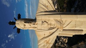 Statue of Jesus Christ with open arms on top of a mountain. Christ of Monteagudo, Murcia, Spain. Traveling out at sunset. Video Vertical de drone