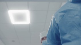 Professional doctors run patient on gurney to operation room down medical center hallway. African American medic talk with patient and checks his condition before operation. Medical staff save life. - Powered by Shutterstock - Get 15% off with code: PIKWIZARD15
