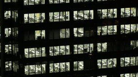 TOKYO, JAPAN : Close up shot of exterior of office building window at night. Company, corporate, job, work and business people concept video.