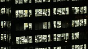 TOKYO, JAPAN : Close up shot of exterior of office building window at night. Company, corporate, job, work and business people concept video. Time lapse shot.