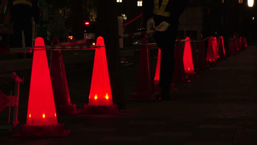 TOKYO, JAPAN : View of road construction at night. Flashing safety cone at the street. Japanese traffic, transportation and construction site concept video. Royalty-Free Stock Footage #3404215717
