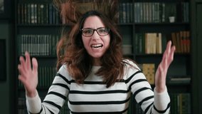 A young brunette woman is angry, screaming and waving her arms. The concept of nervousness and irritation - Powered by Shutterstock - Get 15% off with code: PIKWIZARD15