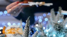 A woman's hand hangs a Christmas toy in the form of a ballerina on a Christmas tree. The concept of happiness at home holiday. High quality 4k footage - Powered by Shutterstock - Get 15% off with code: PIKWIZARD15