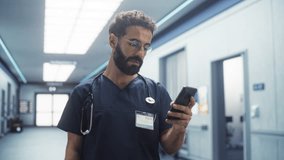 Male Healthcare Nurse Using Smartphone to Check on his Messages and Emails During his Shift. Latin Young Clinic Professional Scrolling on Social Media During his Break in a Modern Hospital Corridor - Powered by Shutterstock - Get 15% off with code: PIKWIZARD15