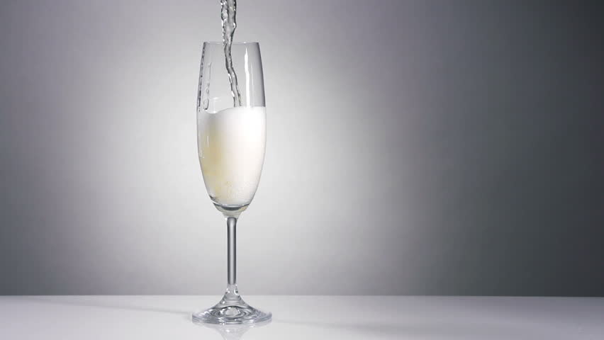 Champagne pouring in glass in slow motion, filmed at 250fps