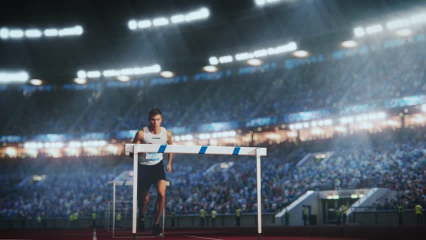Strong Male Athlete is Running Towards an Obstacle, Hurdling, Jumping Over the Barrier in Front of a Stadium of Cheering Fans while Sprinting in a Race. Cinematic Slow Motion Footage with Speed Ramp Royalty-Free Stock Footage #3404442783