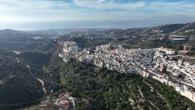 4K video recorded with a drone of a Spanish town between mountains near the coast