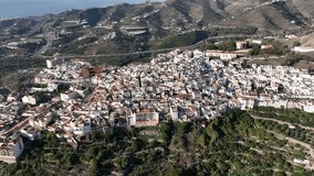 4K video recorded with a drone of a Spanish town between mountains near the coast