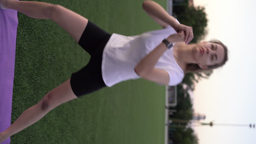 young people doing lunges together during their workout in the park