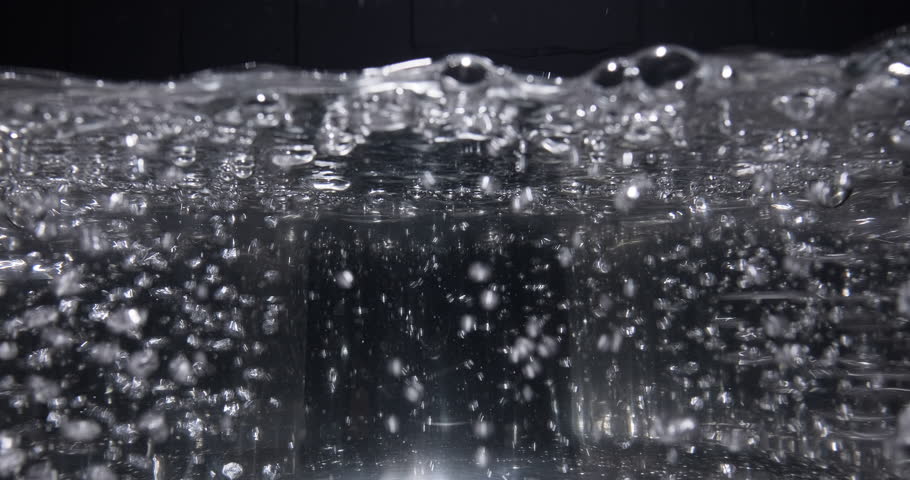 Close-up boiling water in a transparent pan. Boiling water bubbles. Side view, slow motion Royalty-Free Stock Footage #3404602201