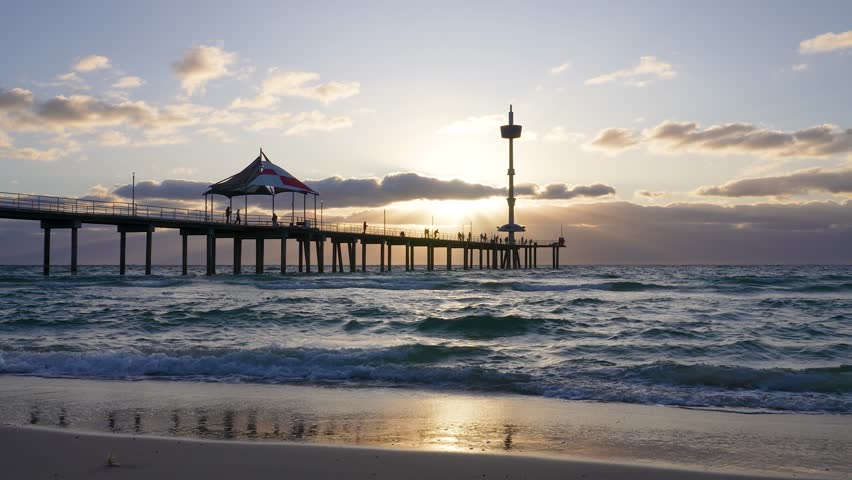 Brighton Beach jetty, waves and reflection at sunset, Adelaide, South Australia