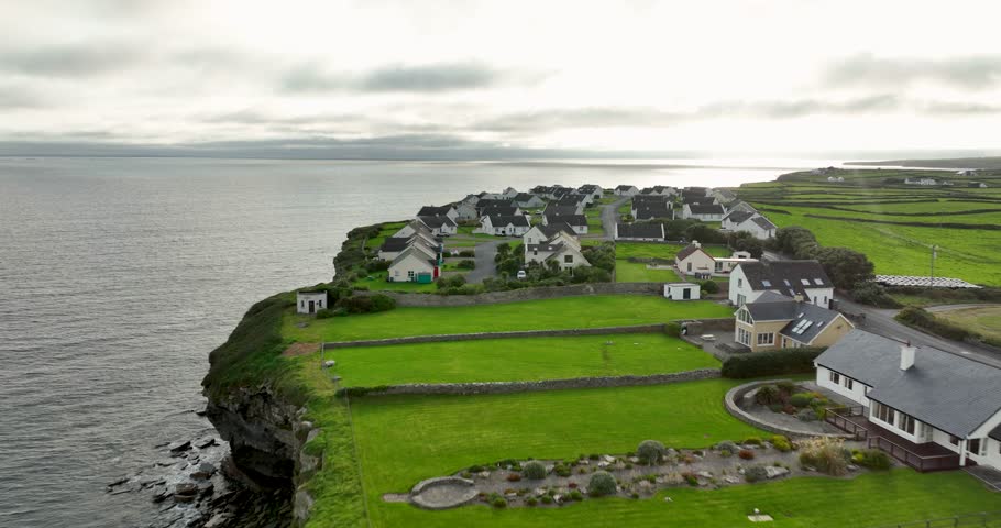 White houses against the ocean on a cloudy day in 4k